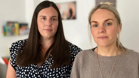 The BBC's Sarah Davies and Annika Thomas look at the camera  